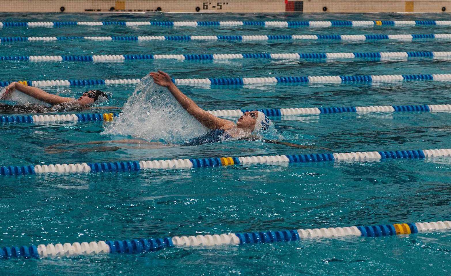 Kate Bailey (in the white swim cap) of O'Connell placed first in the 100 Butterfly and 100 Backstroke.